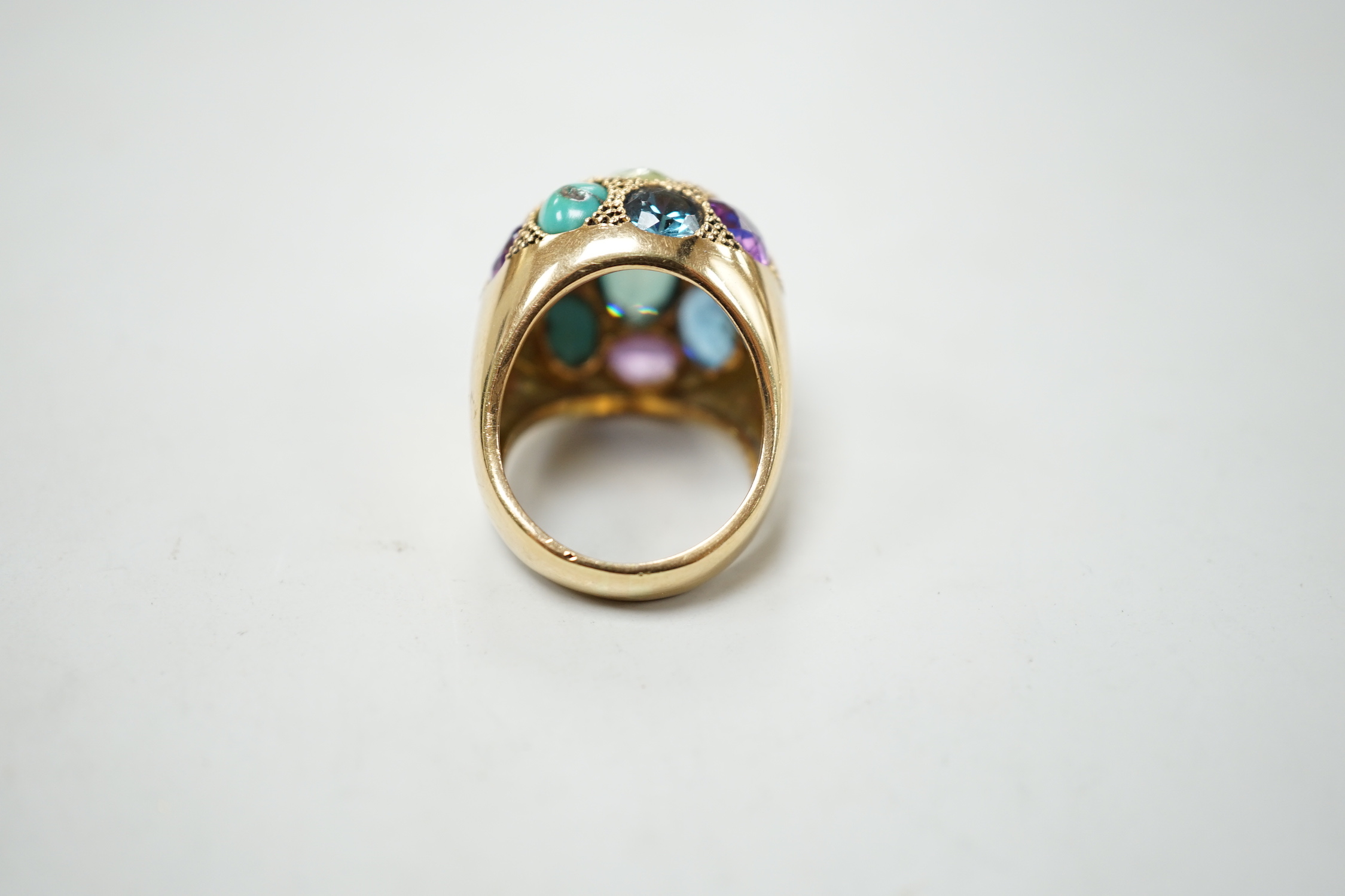 A Middle Eastern yellow metal and multi gem set domed dress ring, size K/L, gross weight 10.5 grams.